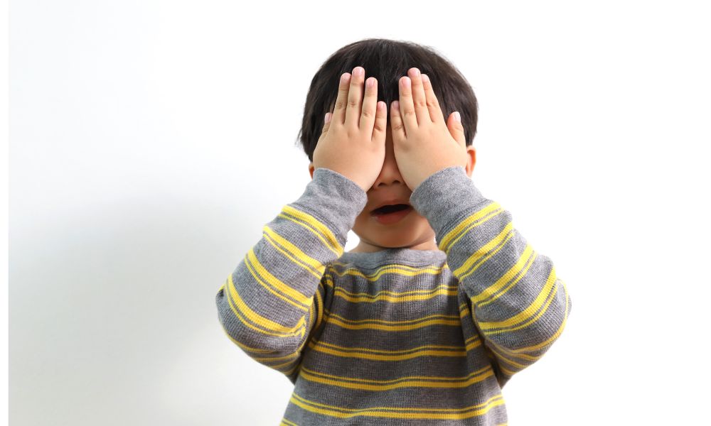 顔の両手をあてて悲しそうな男の子