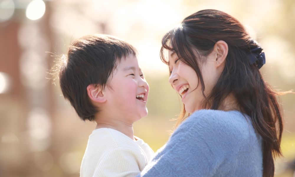 母と息子が顔を見合わせて笑っている様子